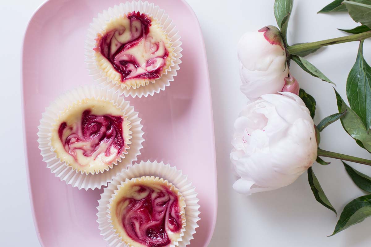 Raspberry cheesecake cupcakes - blog ending image showing the cupcakes with peonies